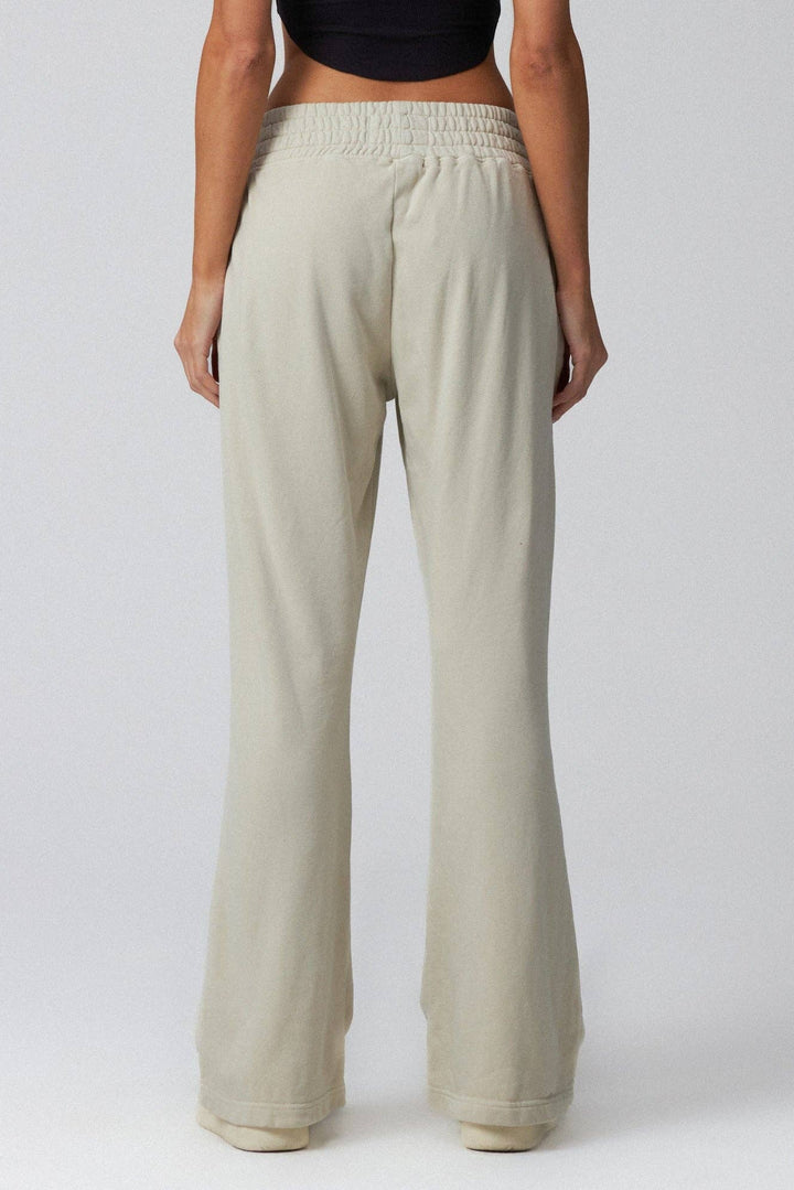 Beige wide-leg pants worn by a person on a white background