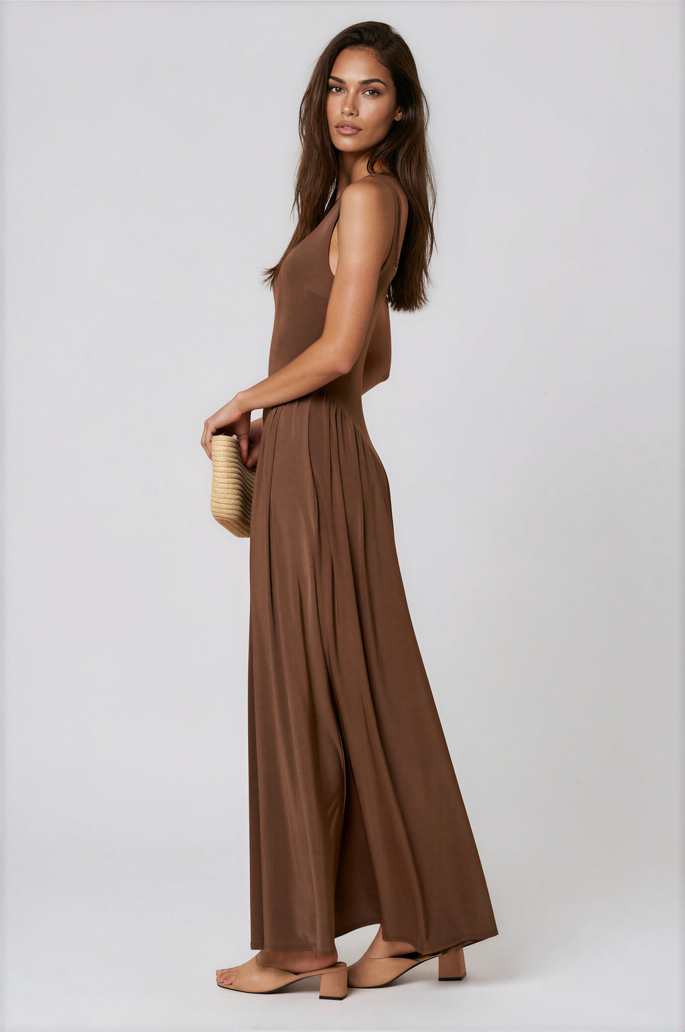 Brown sleeveless jersey maxi dress with fitted bodice and flared skirt
