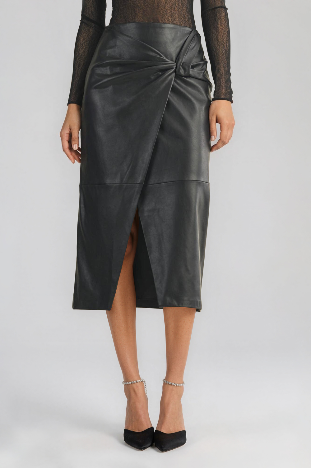 Black vegan leather knot-front wrap skirt in a midi pencil silhouette #color_black