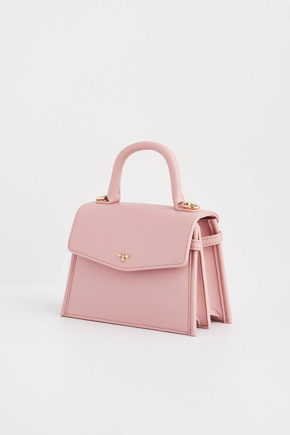 Pink handbag with a handle on a light gray background