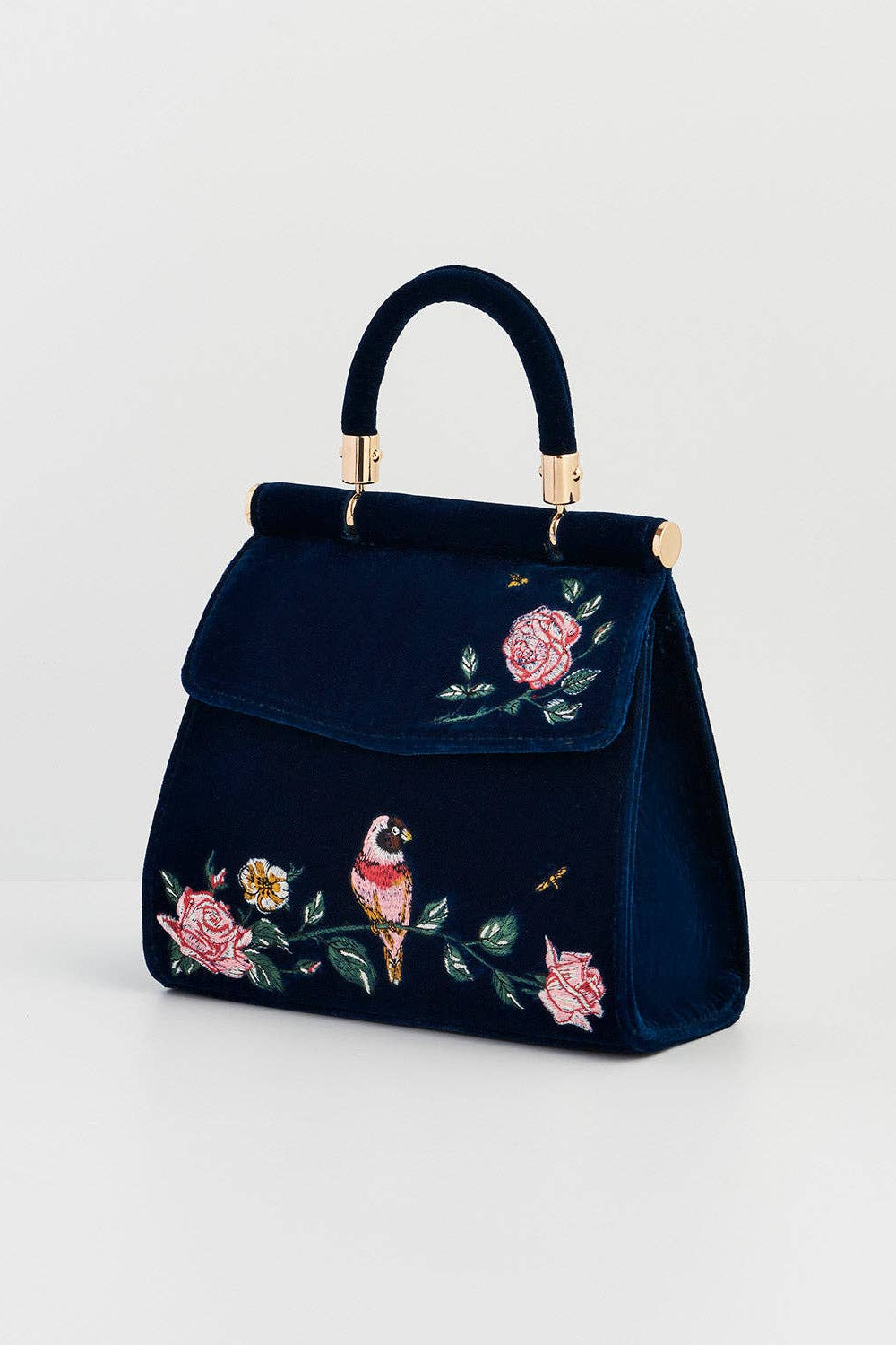 Navy blue handbag with floral and bird embroidery on a light gray background
