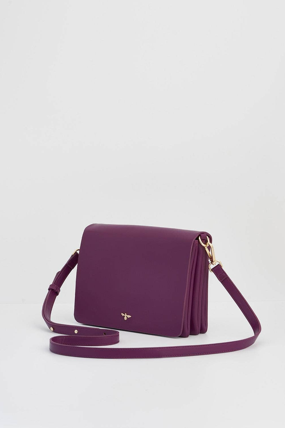 Purple handbag with a gold clasp on a light gray background