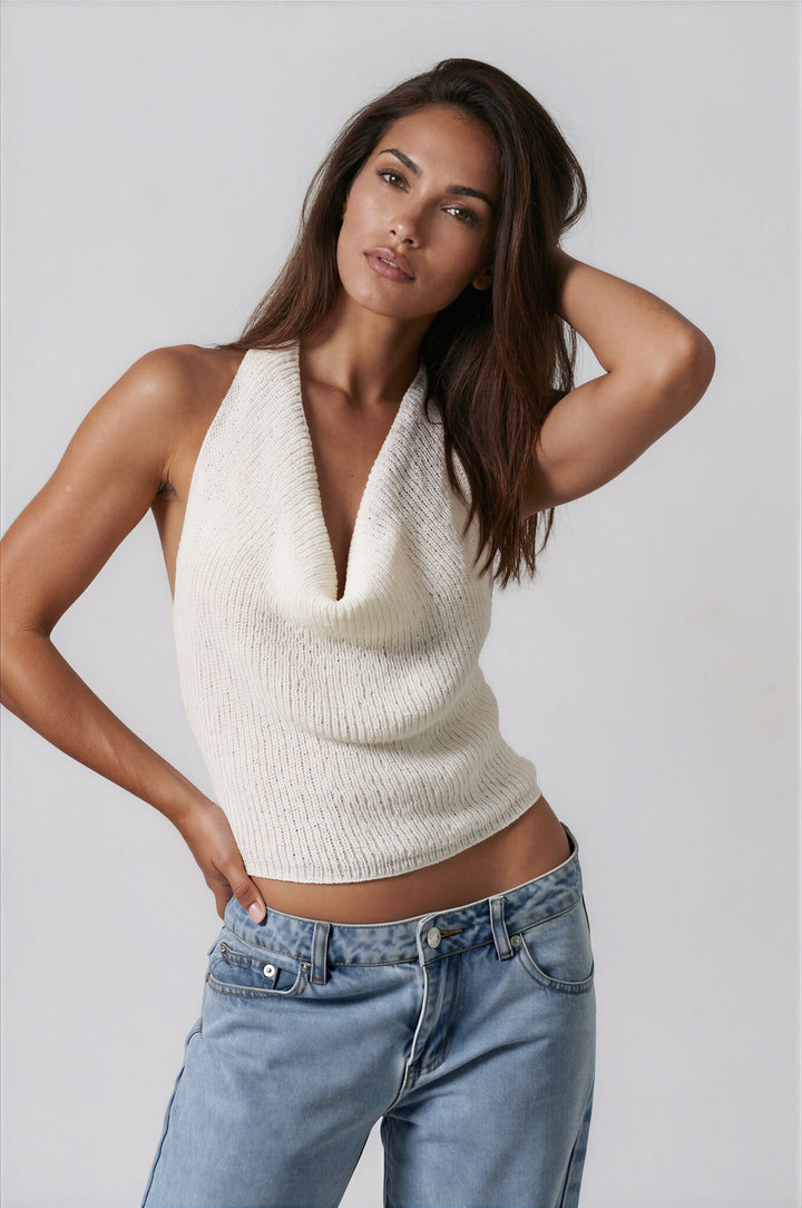 woman wearing white cowl neck halter top