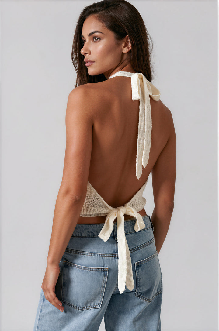 woman wearing white cowl neck halter top