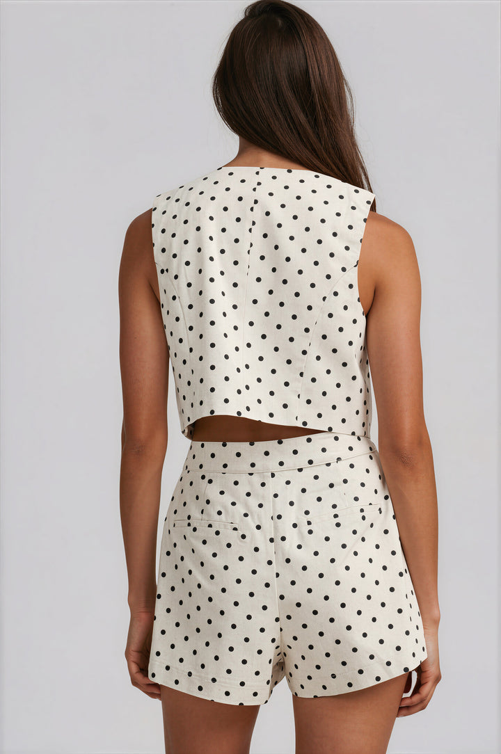 woman wearing beige polka dot linen shorts set