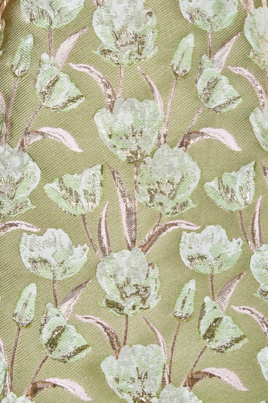 Floral patterned fabric with green tulips on a green background