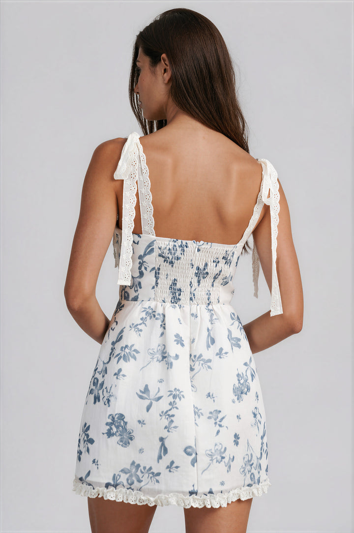 woman wearing white and blue floral mini dress with sweetheart neckline