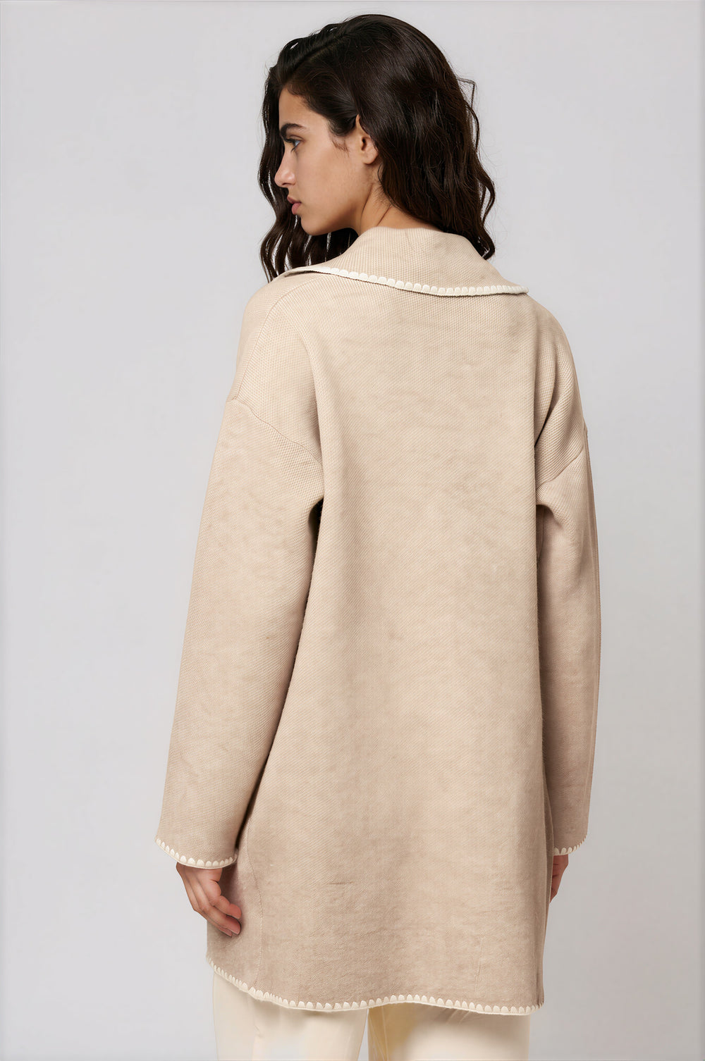 Beige knit sweater jacket with patch pockets and contrast whipstitch trim