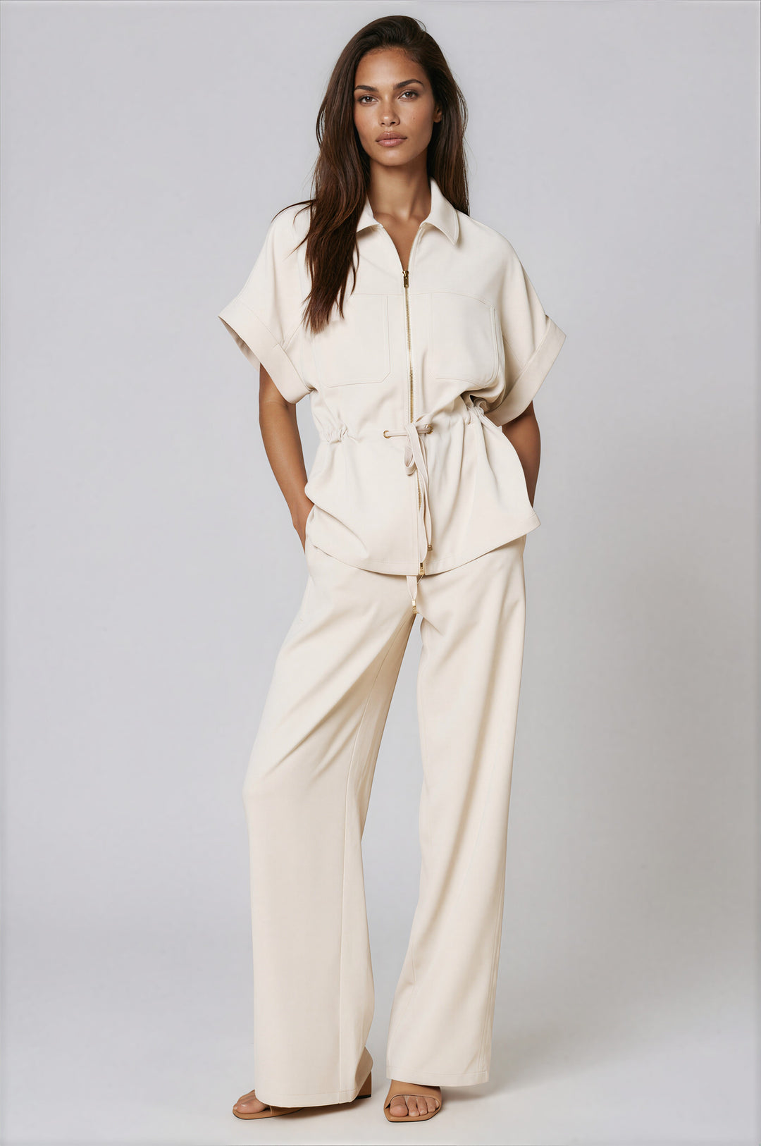 Woman wearing cream collared zip-front top and wide-leg pants set