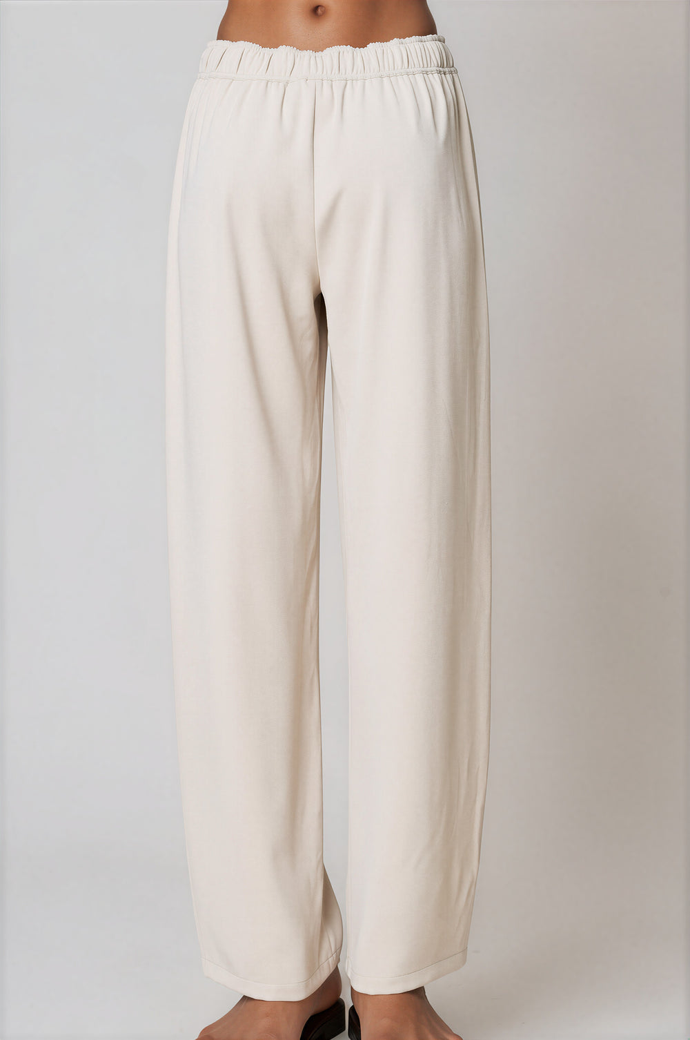Back view of cream wide-leg pants with elasticated waist