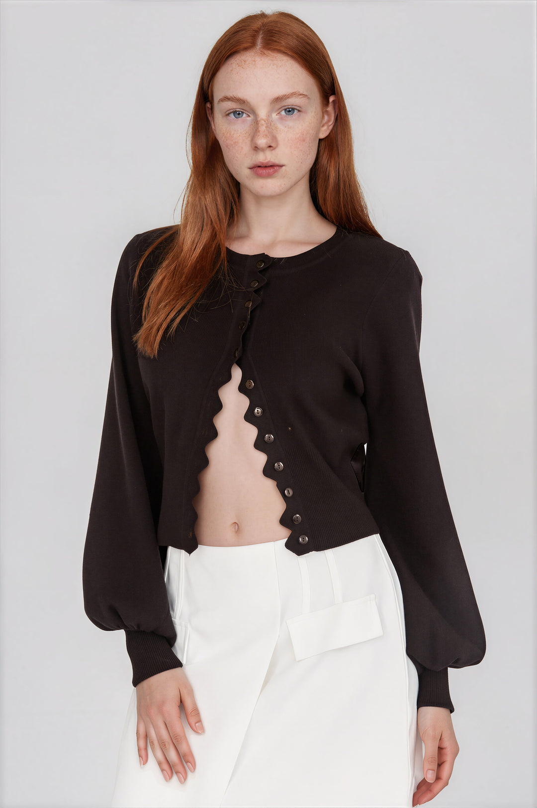 black cardigan sweater with scalloped hem