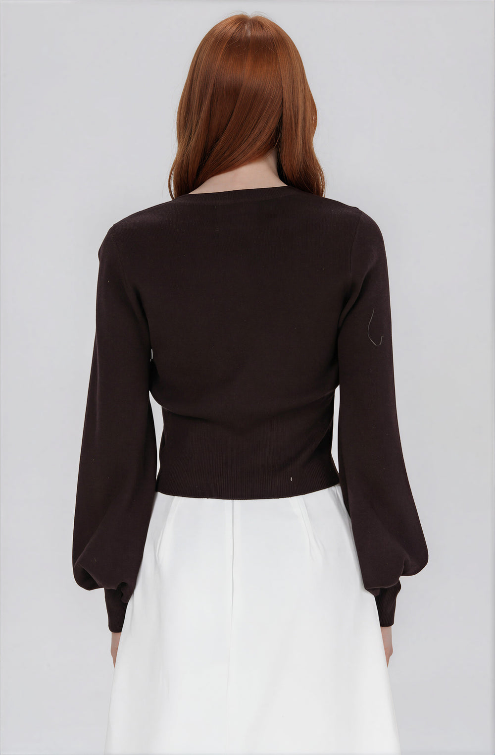 black cardigan sweater with scalloped hem back view