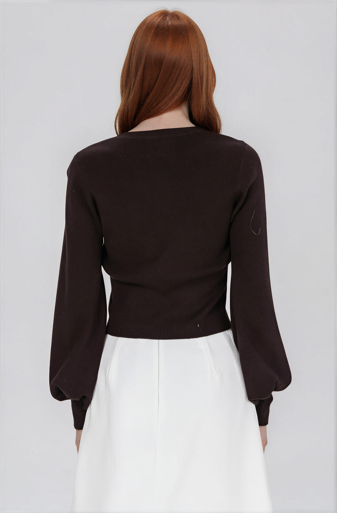 black cardigan sweater with scalloped hem back view