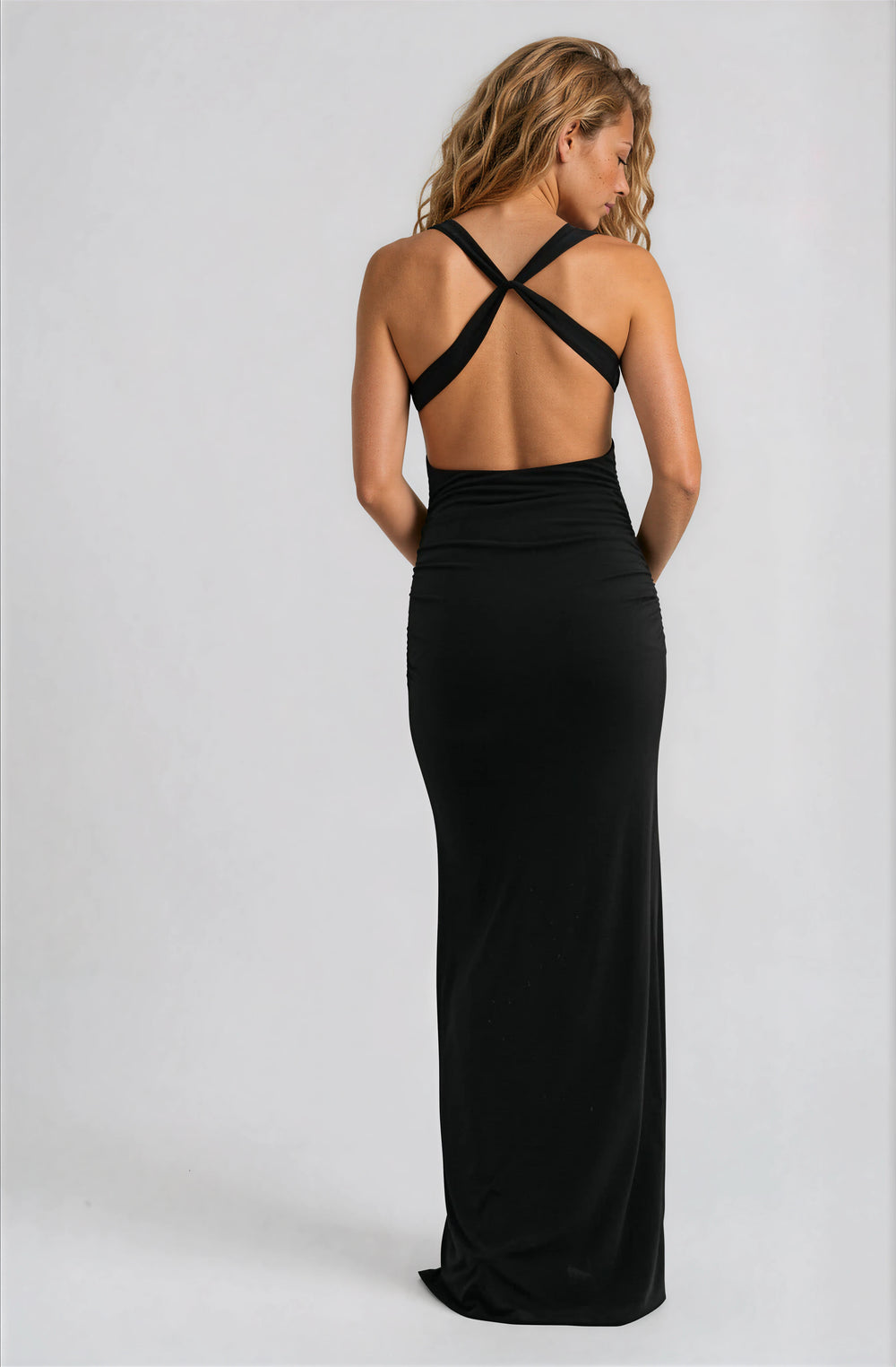 Black fitted maxi dress with subtle ruching and cross straps