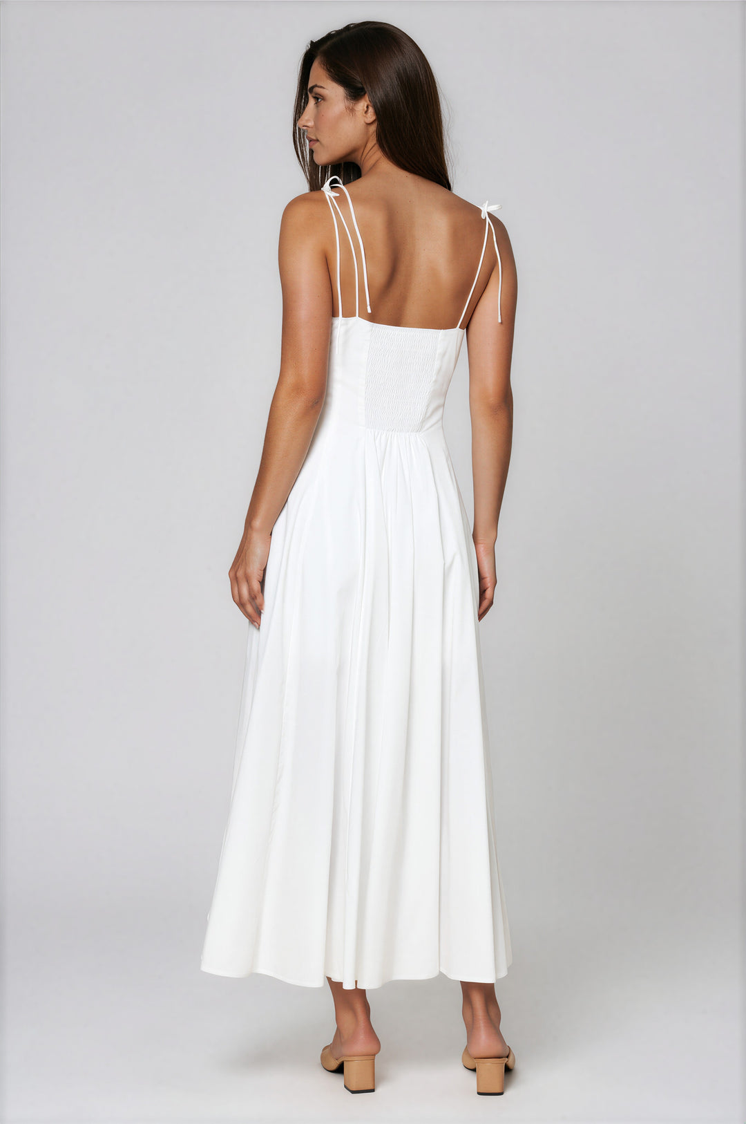 woman wearing a white cotton a-line maxi dress with sweetheart neckline