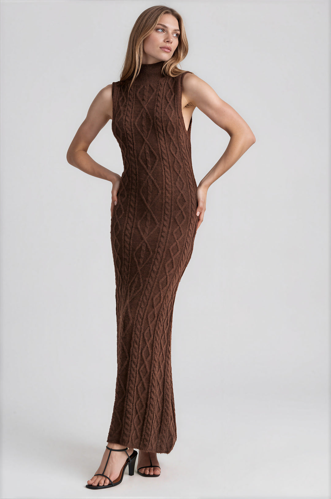 Woman wearing brown sleeveless turtleneck cable knit maxi dress
