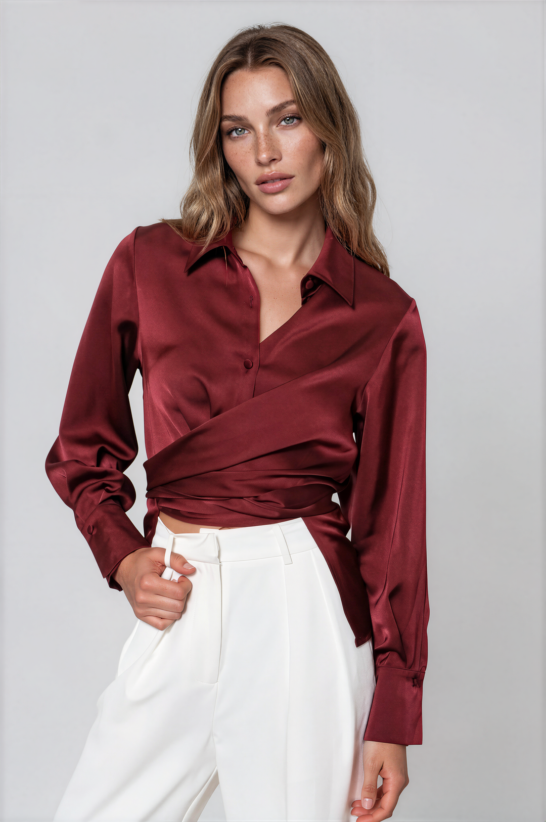 woman wearing red satin blouse with crossover detail