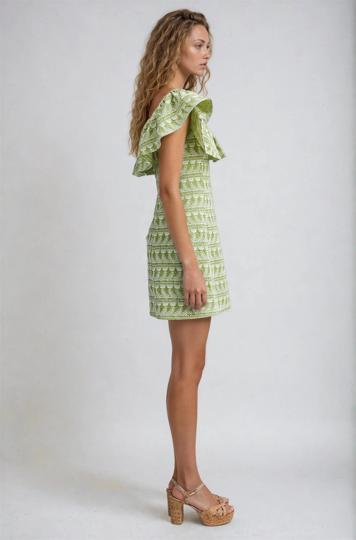 Woman wearing a green patterned dress on a white background