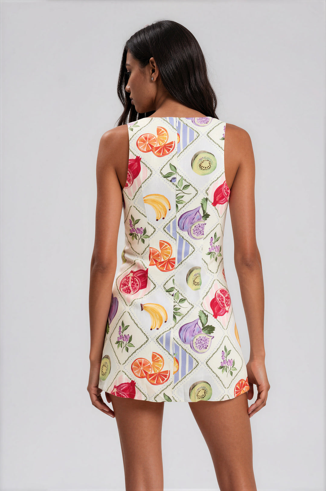 White harlequin fruit print sleeveless mini dress with built-in shorts