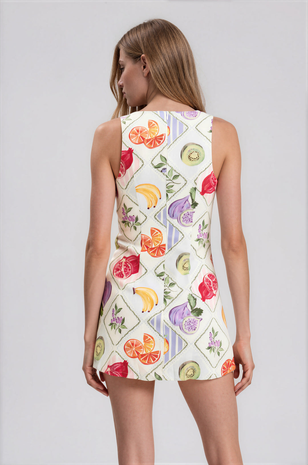 White harlequin fruit print sleeveless mini dress with built-in shorts