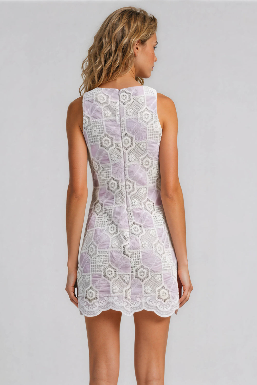 Woman wearing a purple lace dress on a gray background