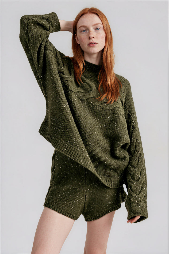 Woman wearing olive oversized cable knit sweater top and matching shorts set