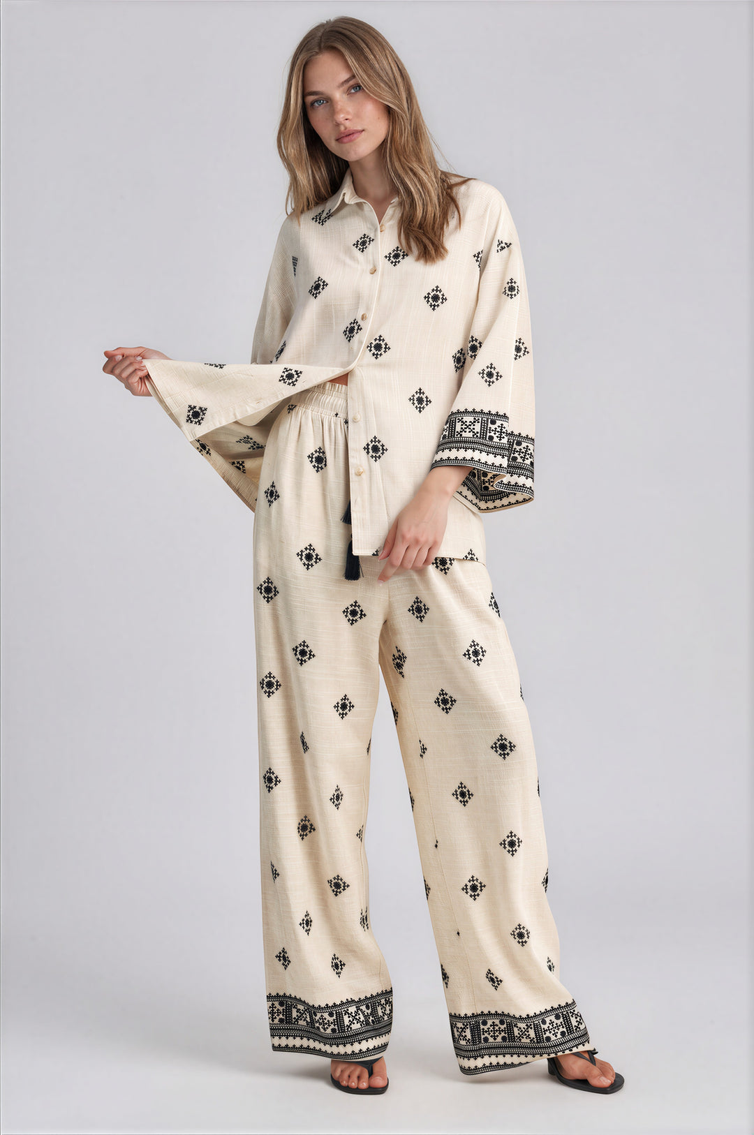 Cream wide leg pants set with black geometric embroidery and oversized button front collared top