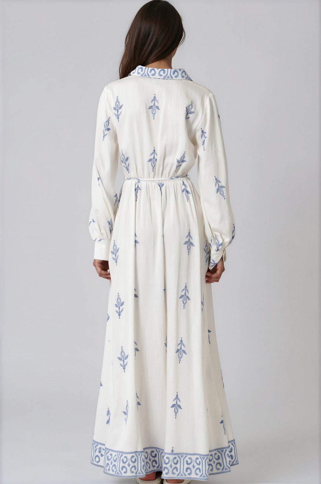 woman wearing ivory and blue long sleeve maxi dress