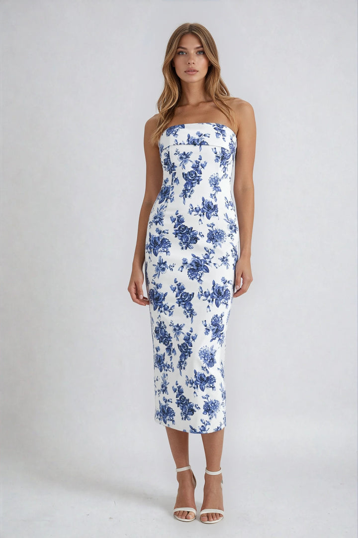 Woman wearing a strapless dress with blue floral pattern on a white background
