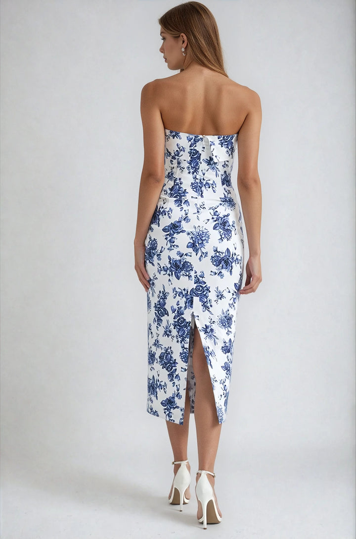 Woman wearing a strapless blue floral dress on a white background