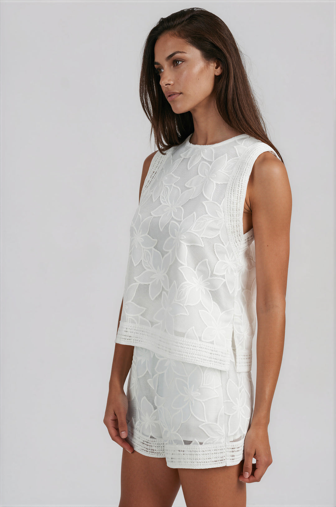 woman wearing white floral lace shorts set