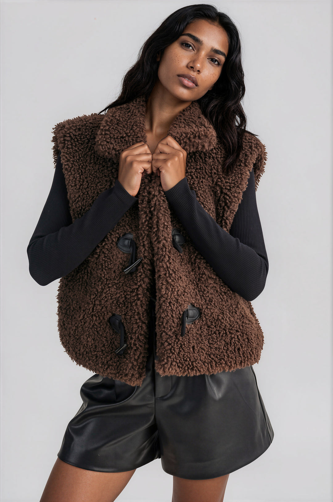 Brown sherpa fleece vest with a collared neckline and toggle buttons, front view