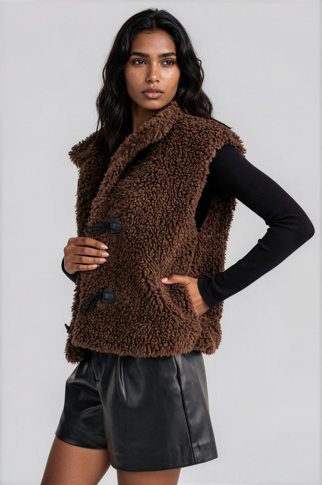 Brown sherpa fleece vest worn as a cool-weather layering piece