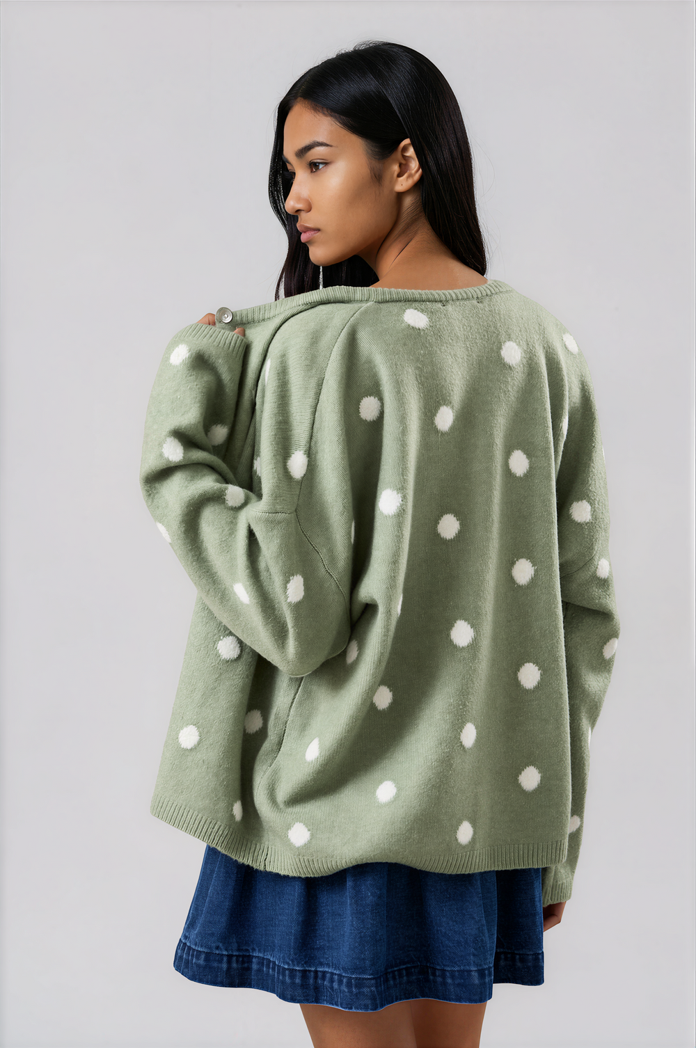 woman wearing sage green polka dot cardigan