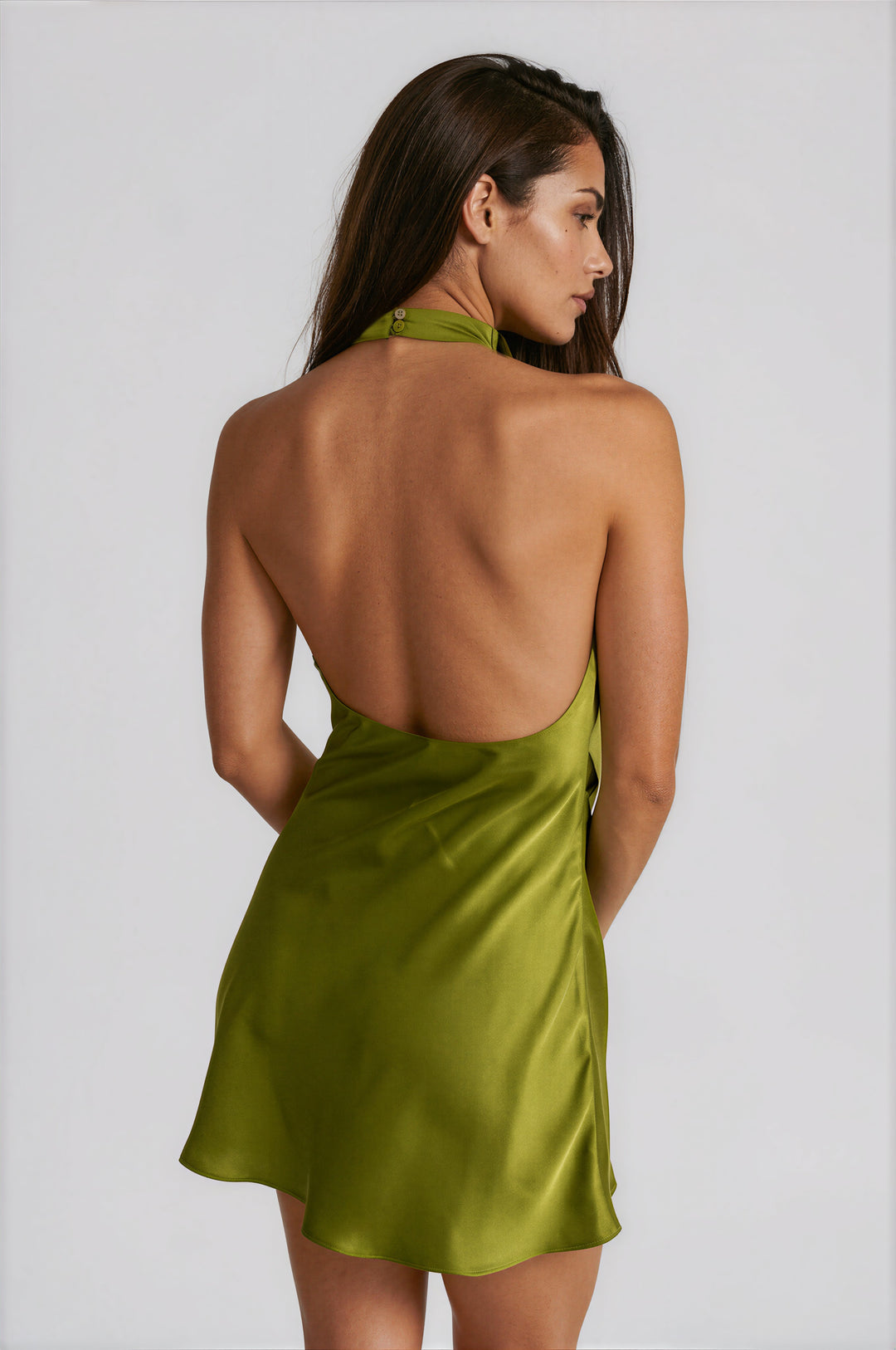 Back view of olive satin halter mini dress with open back and halter button closure