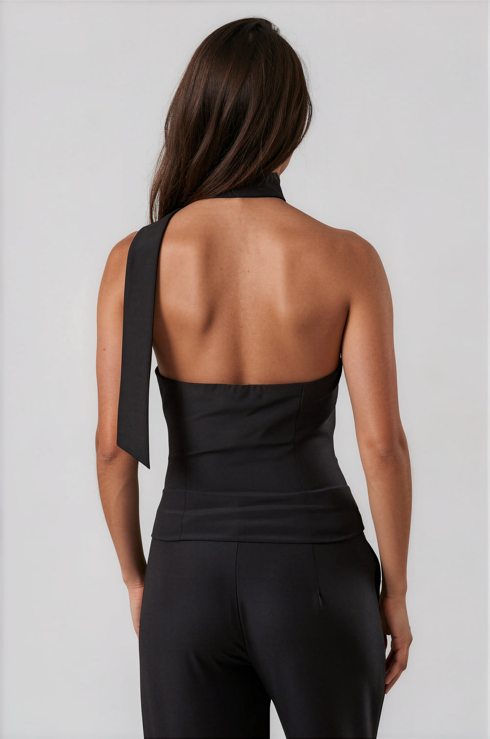 Back view of black halter top with open back and neck tie