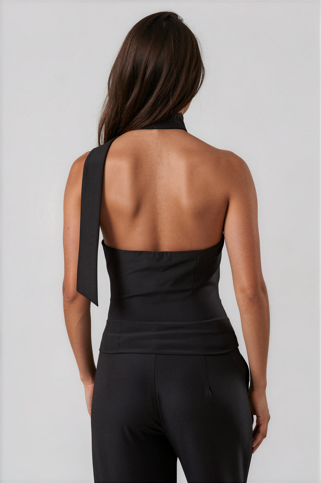 Back view of black halter top with open back and neck tie