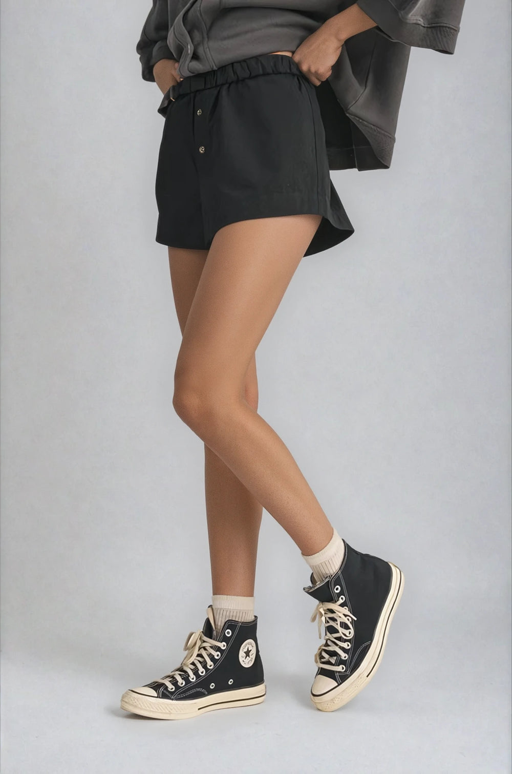 black shorts with elastic waistband and button detail