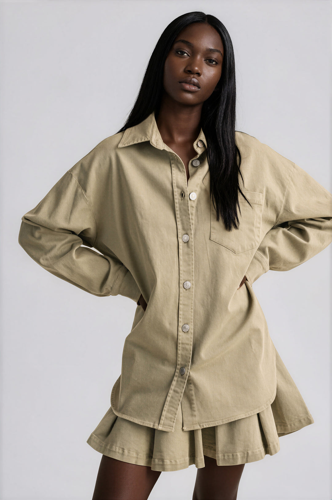 Olive cotton button-down shirt and pleated skirt set styled together