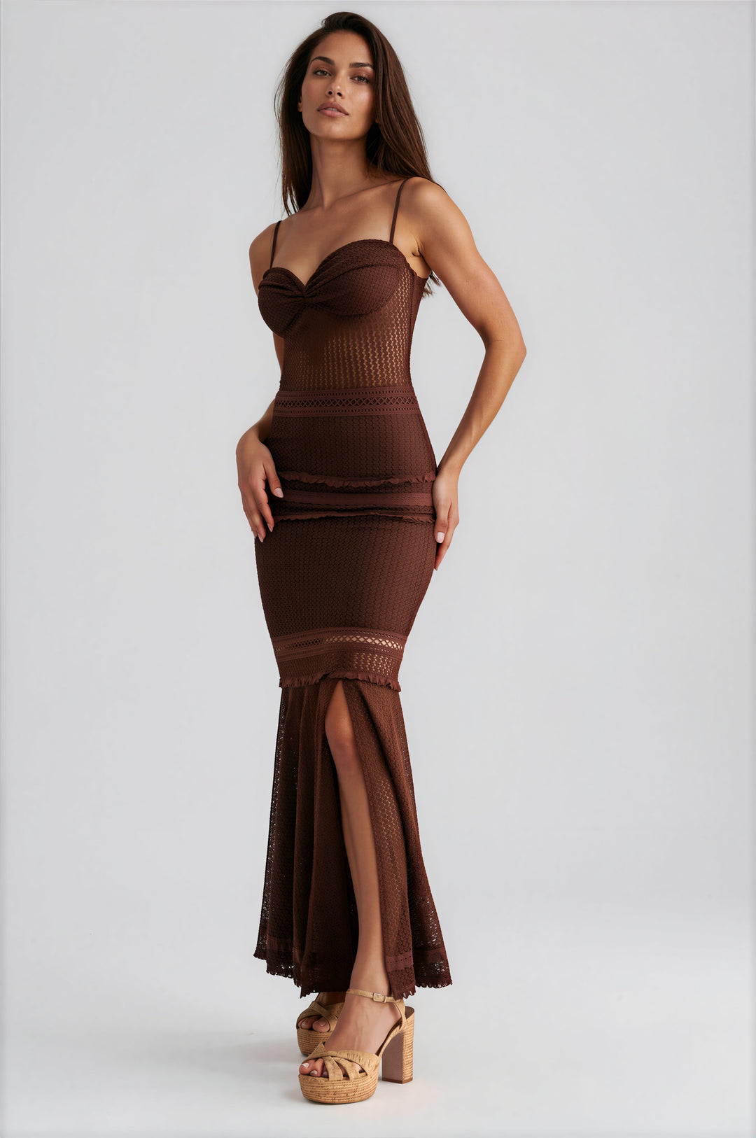 Woman wearing brown crochet knit maxi dress with sweetheart neckline and mermaid silhouette
