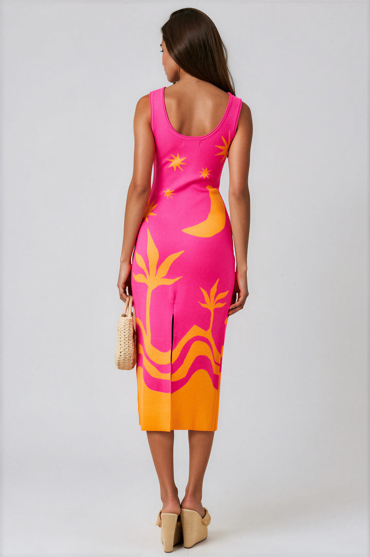 Pink tropical knit midi dress with orange star, moon, and palm motifs