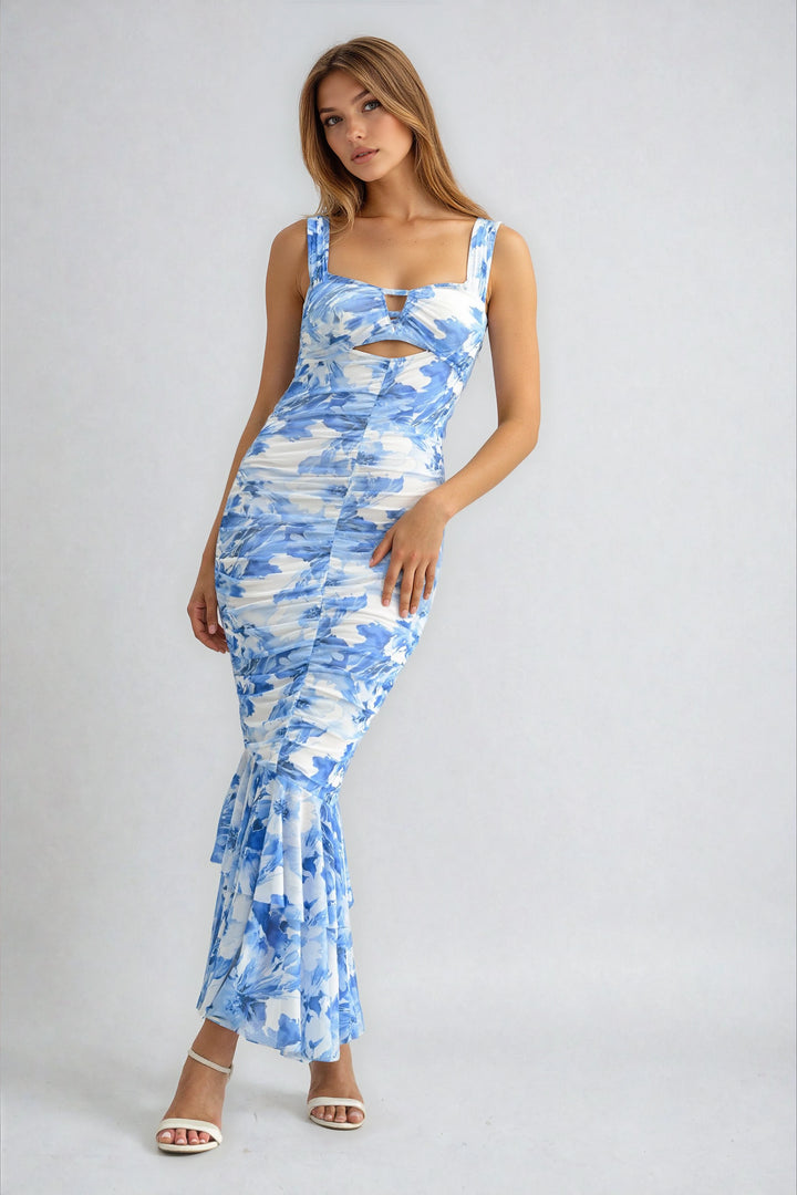 Woman wearing a blue and white patterned dress on a gray background