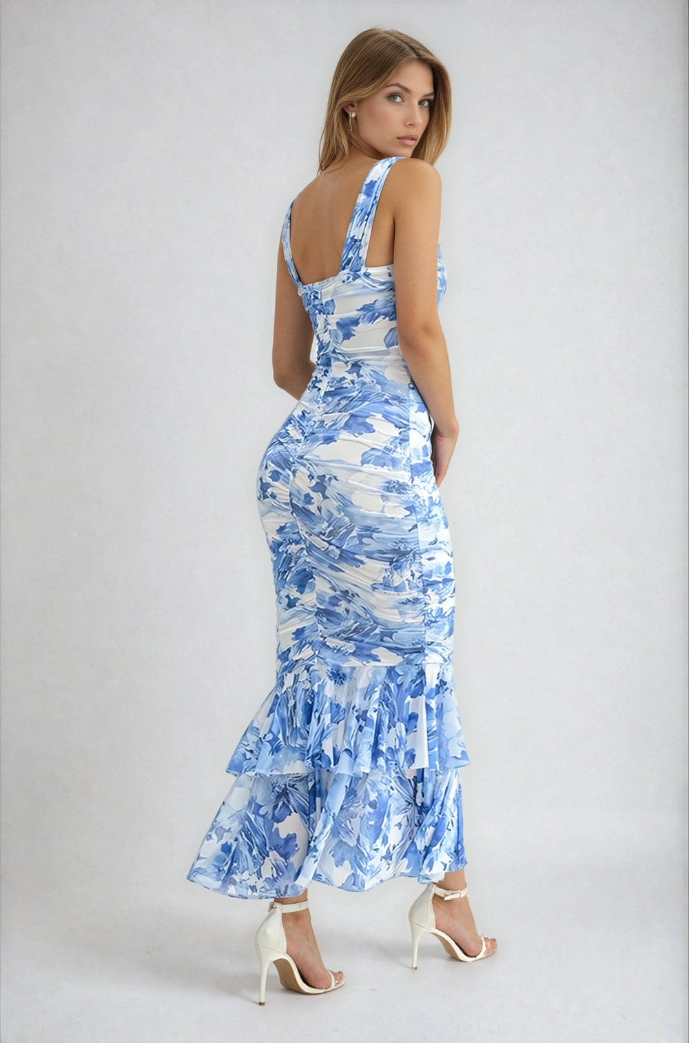 Woman wearing a blue floral dress on a white background