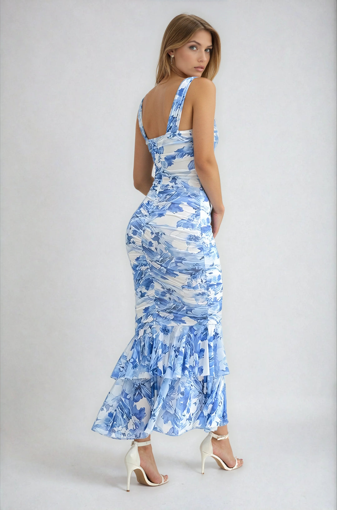 Woman wearing a blue floral dress on a white background