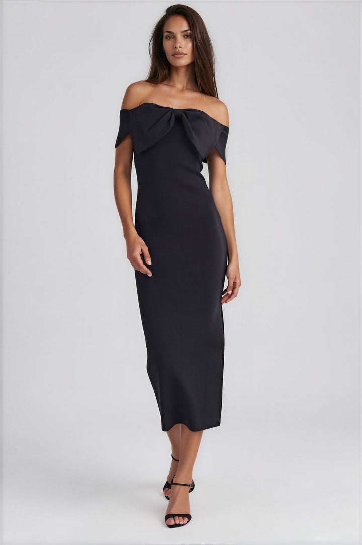 Woman wearing black off-shoulder midi dress with contrast bow detail and side slit