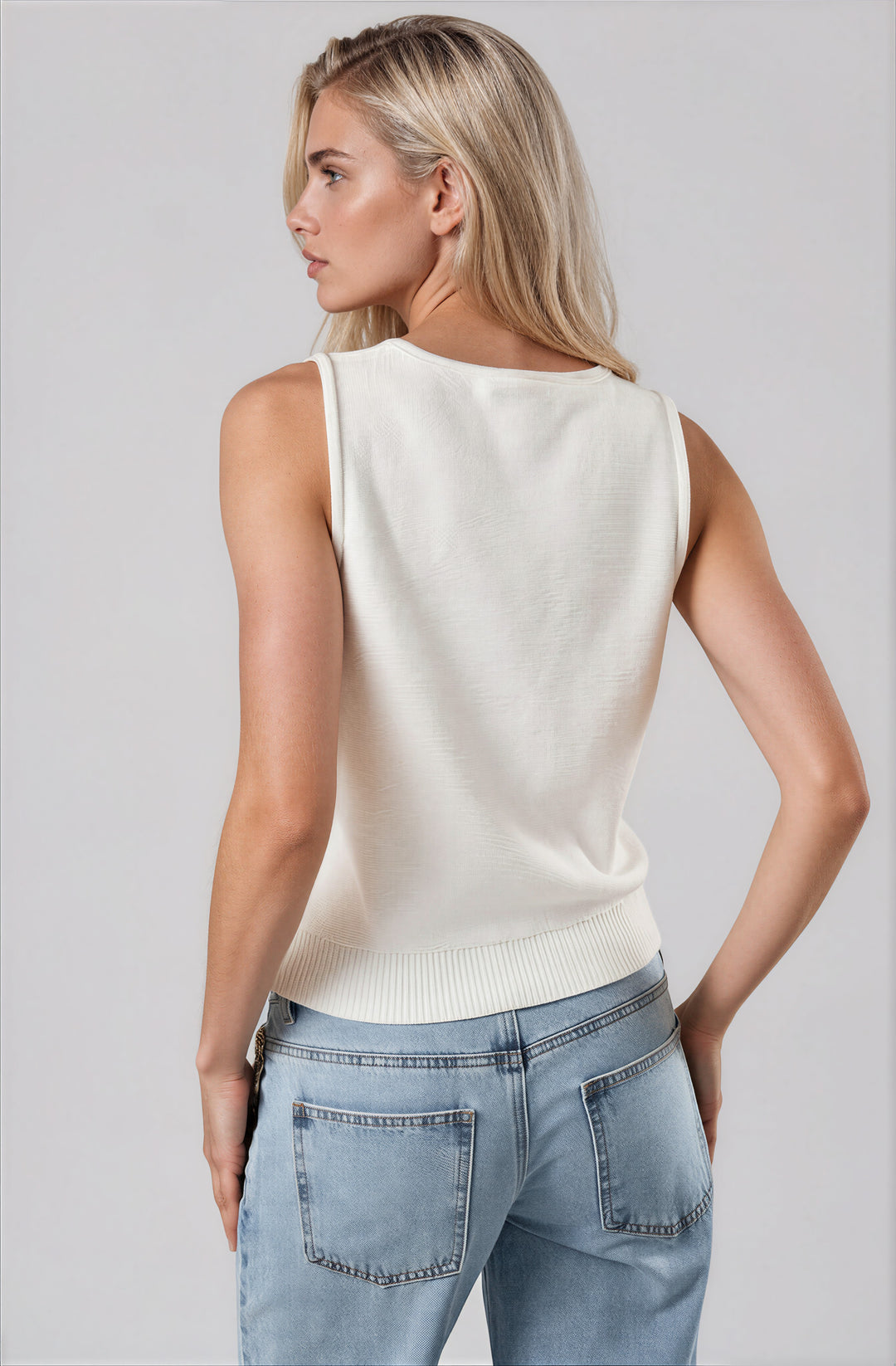 white sleeveless sweater top with embroidered spritz detail back view