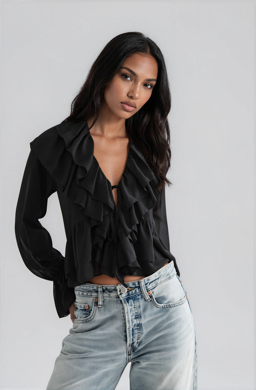 Front view black ruffled tie front blouse on model