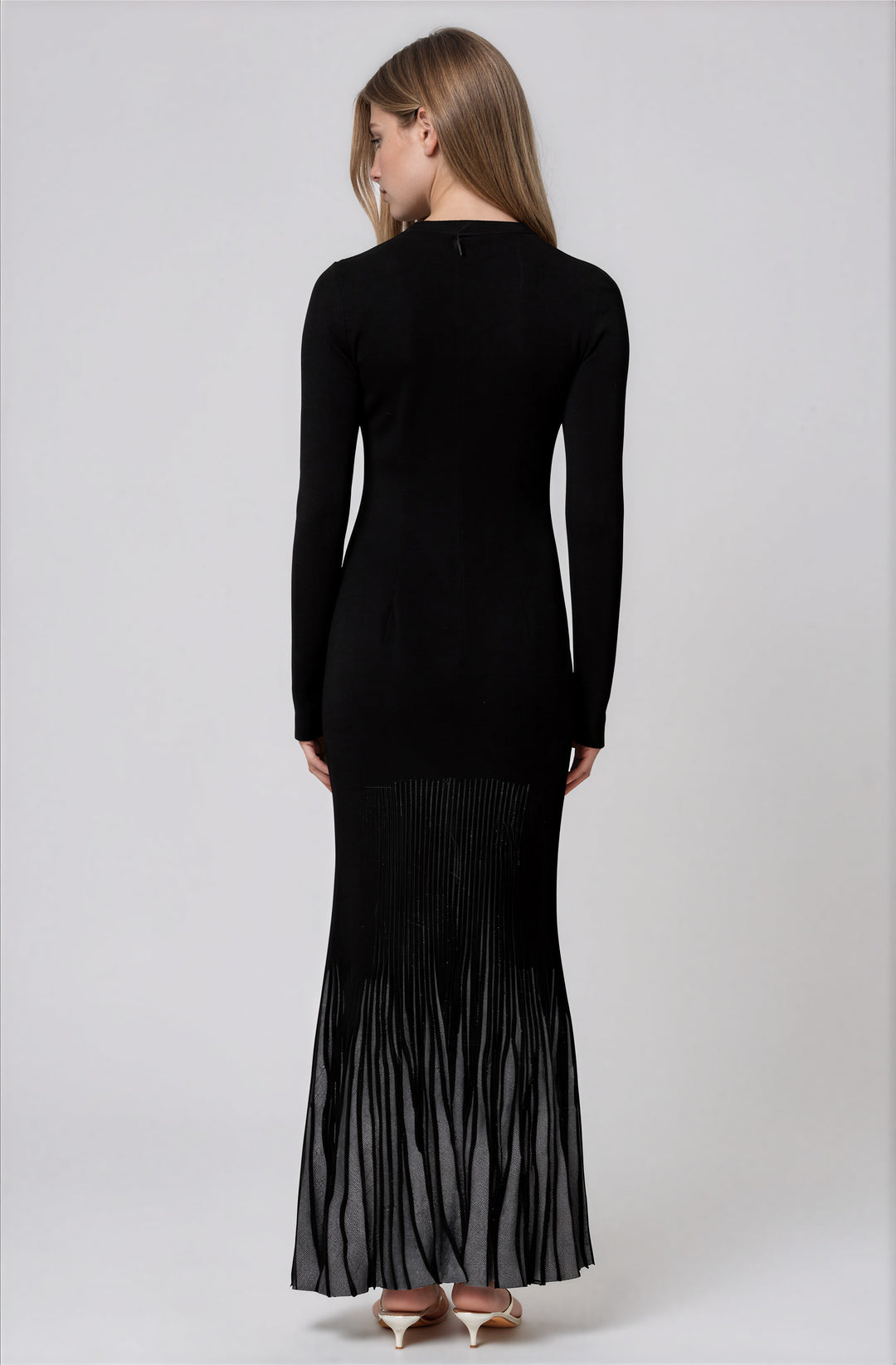 long sleeve black sweater maxi dress with silver pleated skirt detail back view