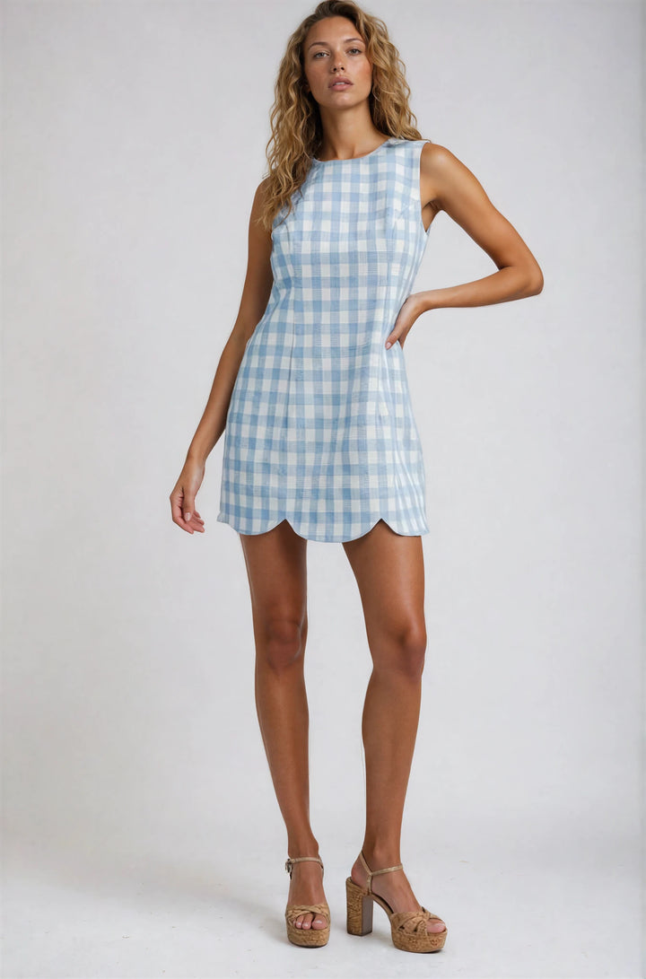 Woman wearing a light blue checkered dress on a white background