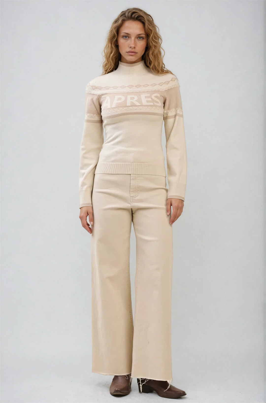 Model wearing Apres Sweater knit pullover with après graphic and mock neckline